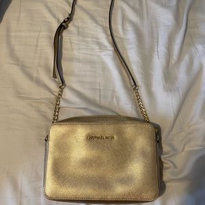 Gold Michael Kors cross body purse.
